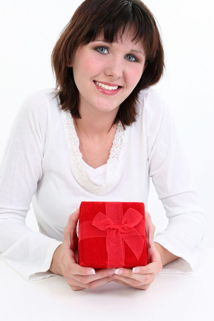 Smiling woman holding a red gift box